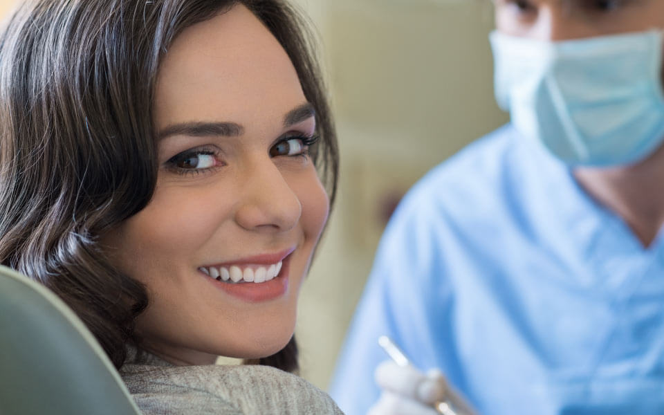 woman in dentist office smiling